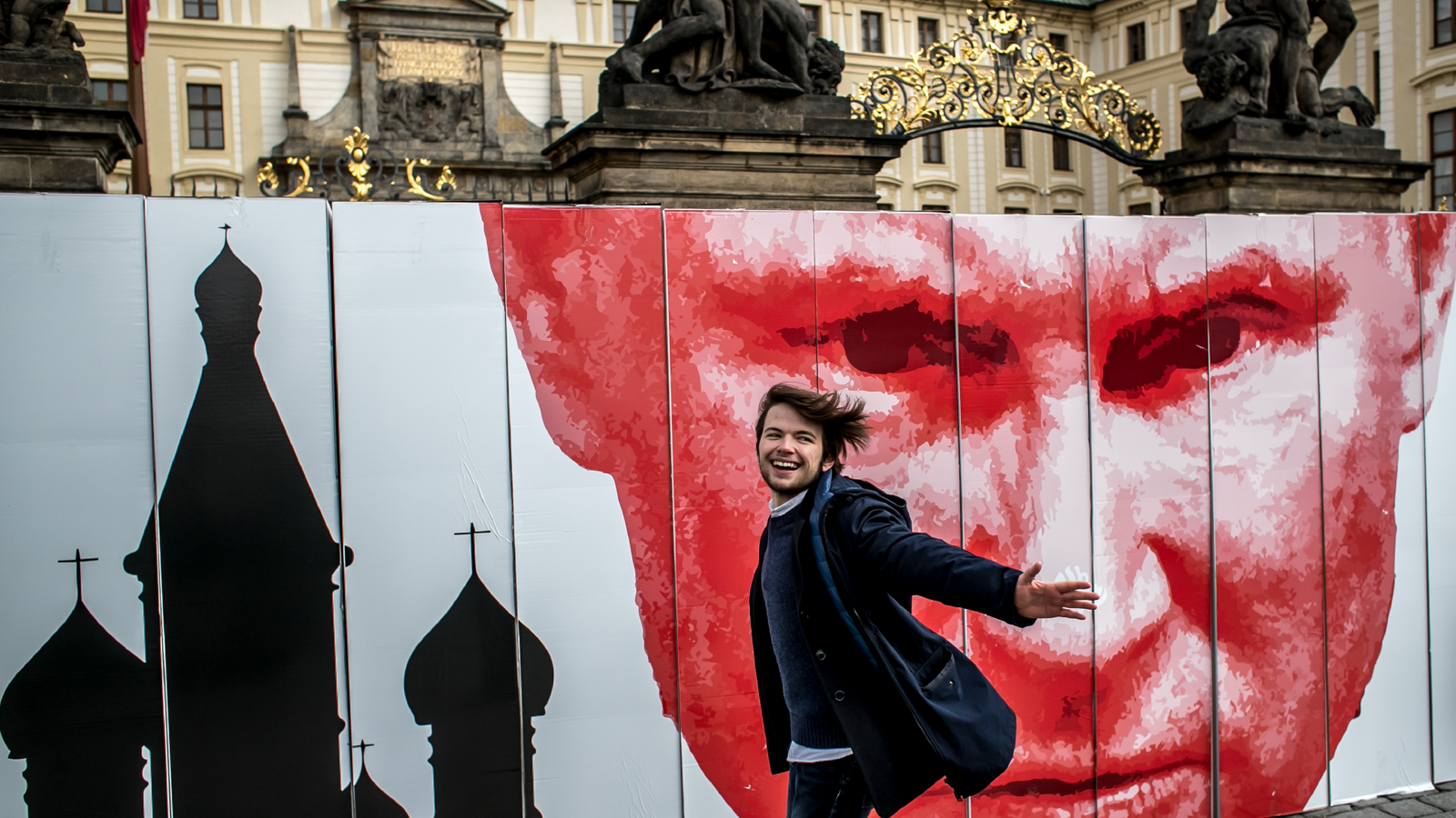 A man passes a symbolic wall during a protest in front of the Prague Castle.